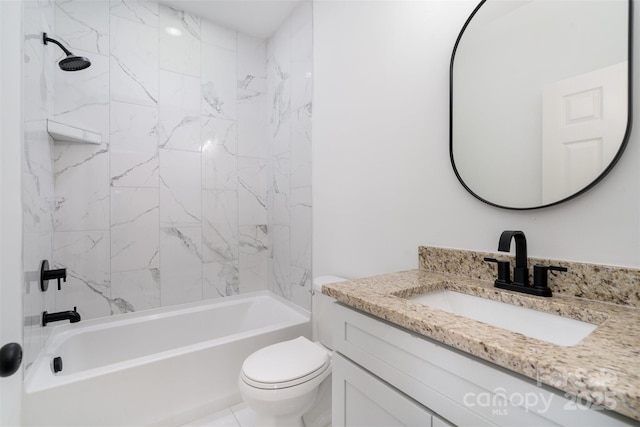 full bathroom featuring tiled shower / bath, vanity, and toilet