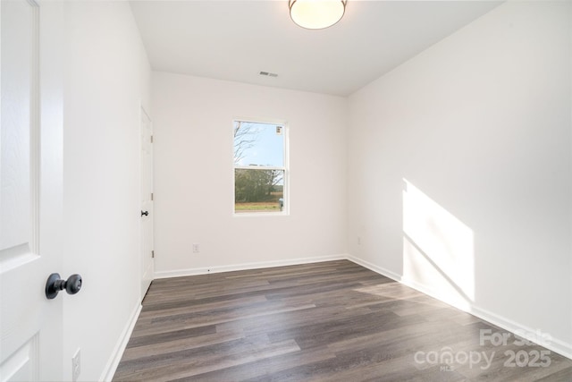 unfurnished room with dark hardwood / wood-style floors