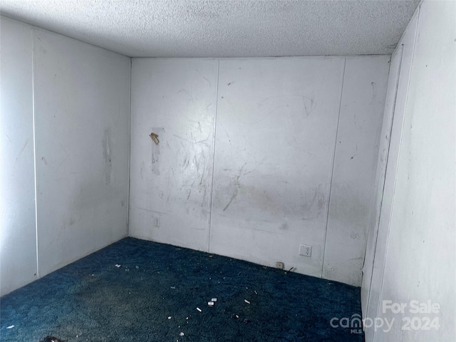 empty room featuring a textured ceiling