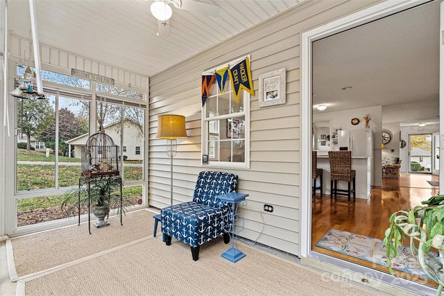 sunroom / solarium featuring ceiling fan