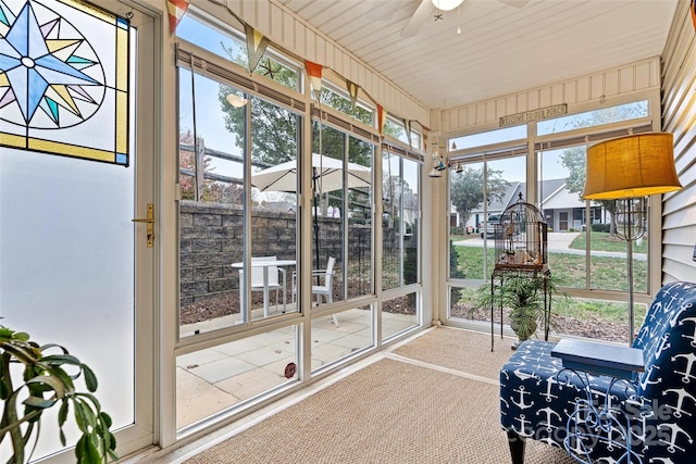 sunroom featuring ceiling fan and a healthy amount of sunlight