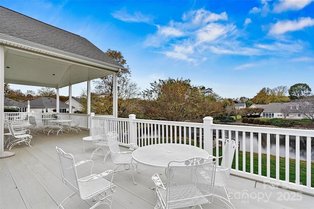 view of patio with a deck with water view