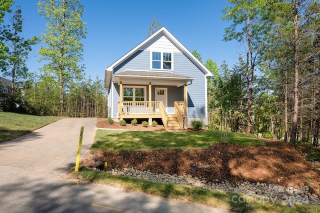 view of front of home featuring a front yard and a porch