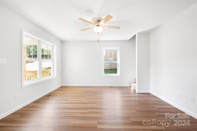 empty room with ceiling fan and wood-type flooring