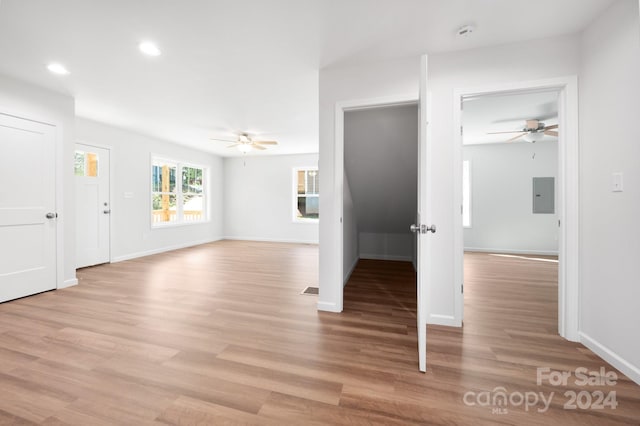 interior space featuring ceiling fan, light wood-type flooring, and electric panel