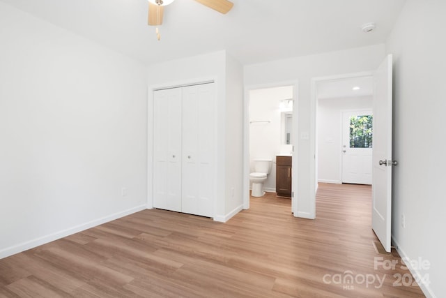 unfurnished bedroom with connected bathroom, a closet, ceiling fan, and light hardwood / wood-style floors