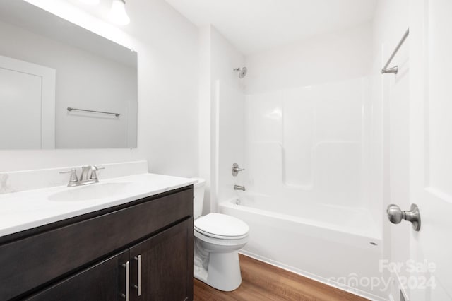 full bathroom featuring wood-type flooring, vanity, toilet, and tub / shower combination