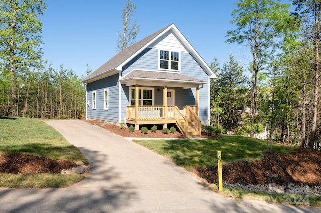 view of front of property featuring covered porch and a front yard