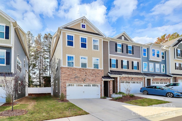 multi unit property with a front lawn and a garage