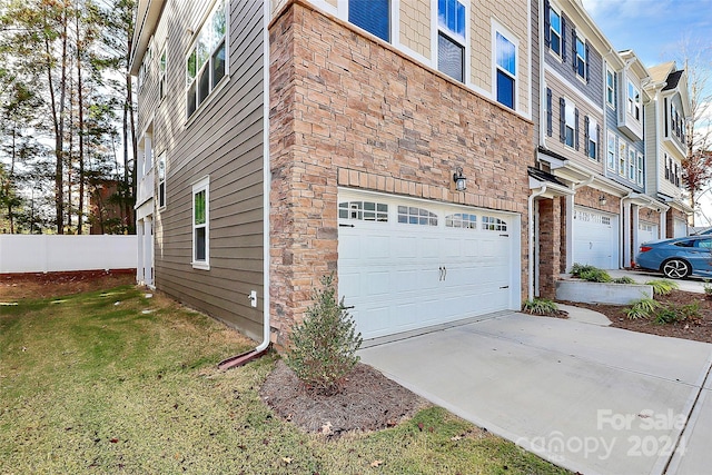 view of side of home with a garage and a yard