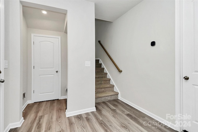 stairway with hardwood / wood-style flooring