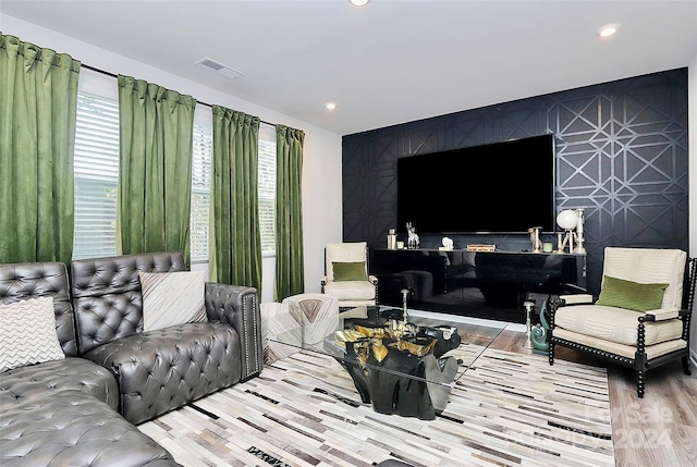 living room with light wood-type flooring and a wealth of natural light