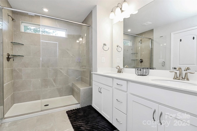 bathroom featuring vanity, tile patterned flooring, and a shower with door