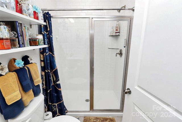 bathroom with a shower with door and toilet