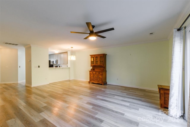 unfurnished living room featuring crown molding, light hardwood / wood-style floors, and ceiling fan