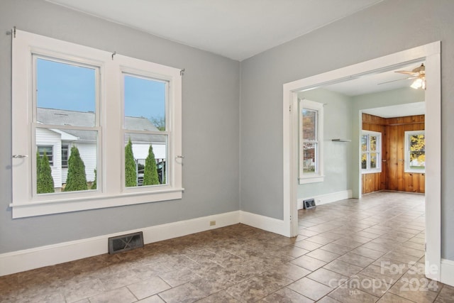 unfurnished room with light tile patterned floors and ceiling fan