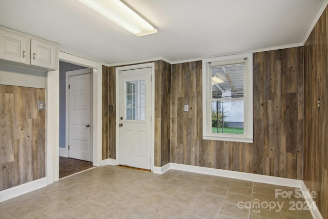 entryway featuring wood walls