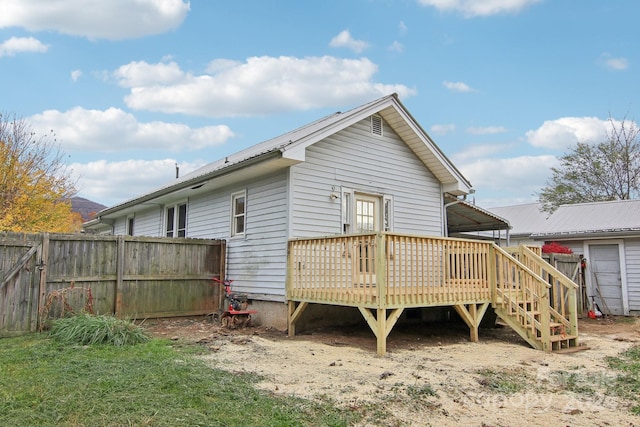 rear view of house featuring a wooden deck