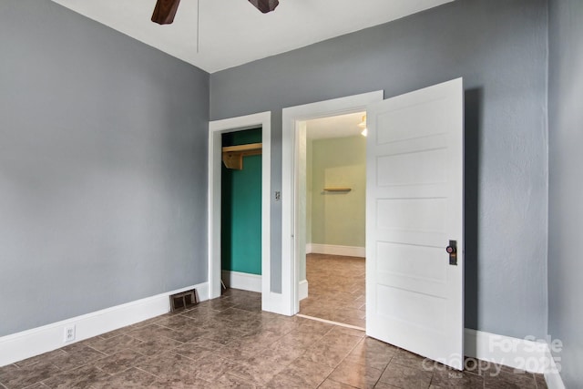 unfurnished bedroom featuring ceiling fan