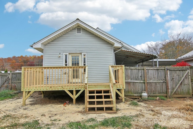 rear view of house featuring a deck