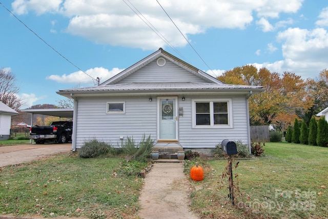 bungalow with a carport and a front lawn