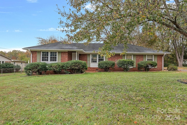 ranch-style home featuring a front yard