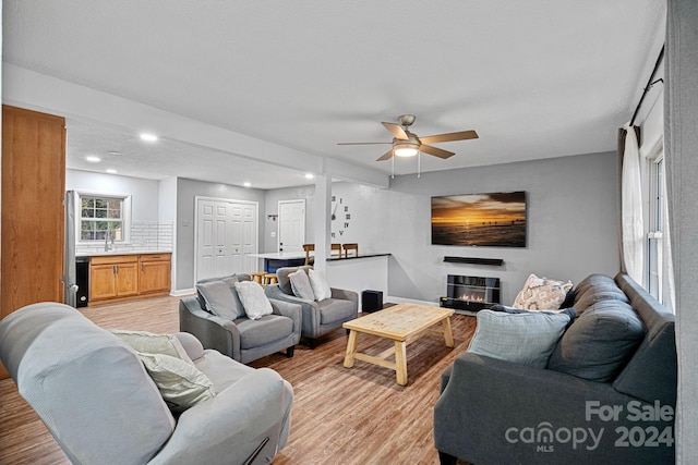 living room featuring ceiling fan and light wood-type flooring