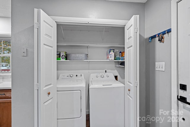 clothes washing area with independent washer and dryer