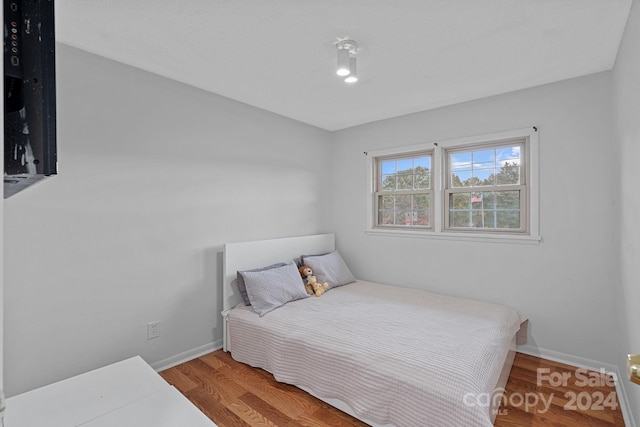 bedroom with hardwood / wood-style floors