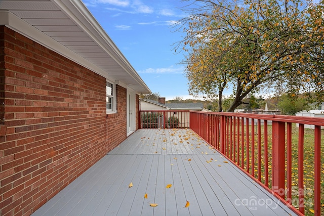 wooden terrace featuring a yard