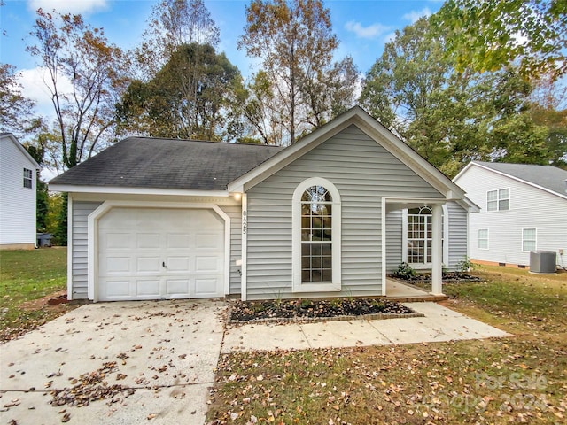 ranch-style home with a garage and cooling unit