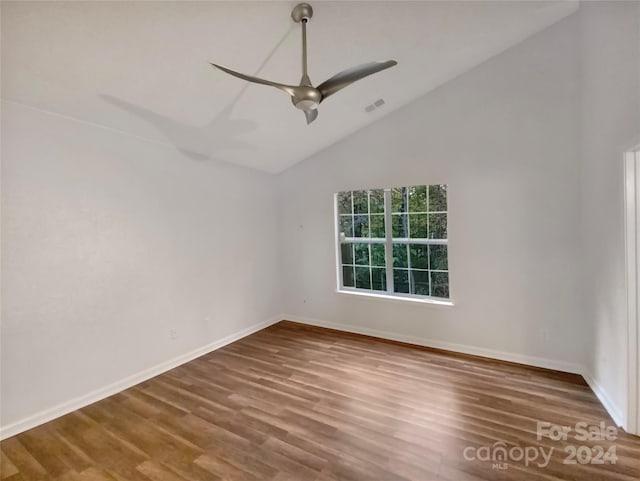 empty room featuring high vaulted ceiling, wood-type flooring, and ceiling fan