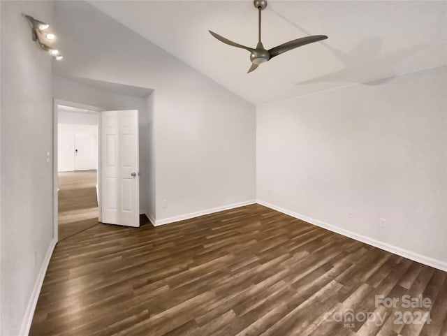 unfurnished room with lofted ceiling, ceiling fan, and dark hardwood / wood-style flooring