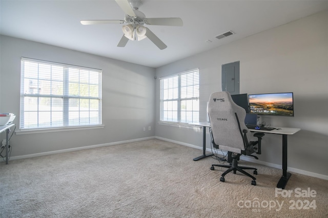 office featuring ceiling fan, light carpet, and electric panel