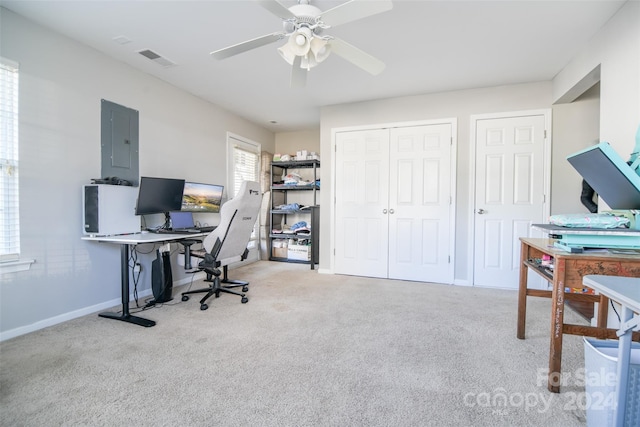 carpeted office featuring electric panel and ceiling fan