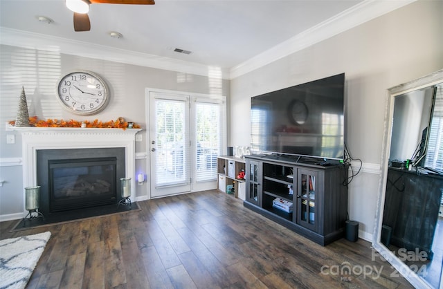 living room featuring dark hardwood / wood-style flooring, ceiling fan, and crown molding