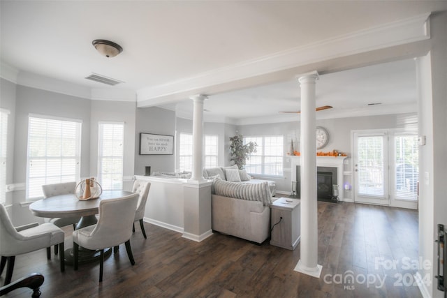 dining room featuring dark hardwood / wood-style flooring, crown molding, and a wealth of natural light