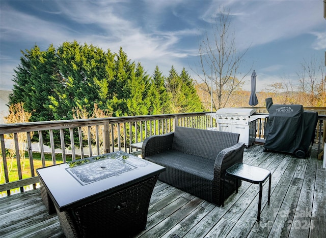 wooden terrace with grilling area and an outdoor living space