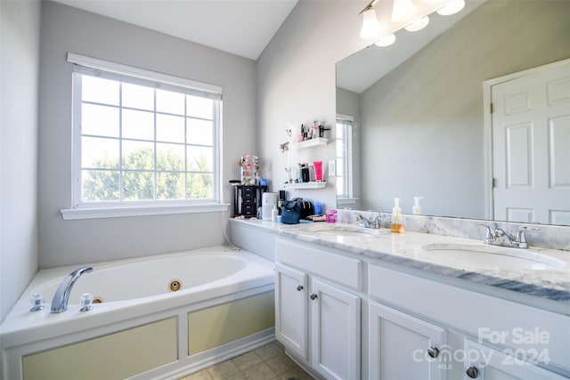 bathroom featuring vanity, lofted ceiling, and a bath