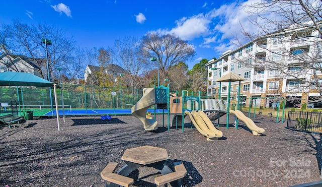 view of playground with tennis court