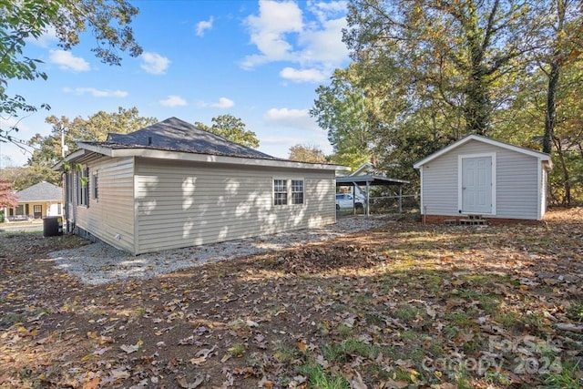 back of property featuring a storage unit