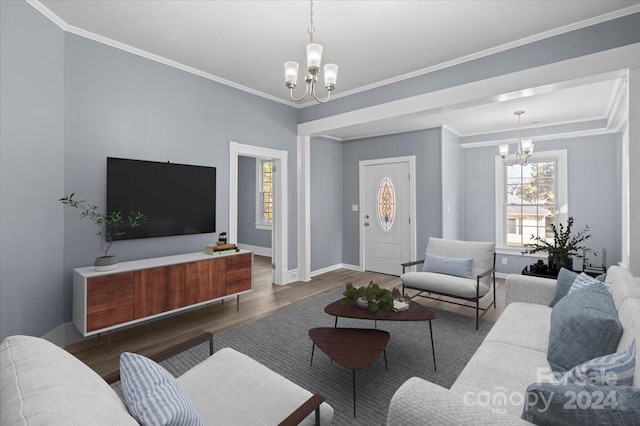 living room with ornamental molding, a chandelier, and dark wood-type flooring