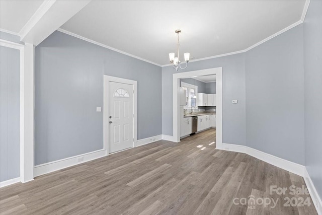 interior space featuring an inviting chandelier, light wood-type flooring, and crown molding