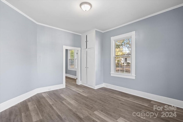 unfurnished room featuring crown molding and hardwood / wood-style flooring