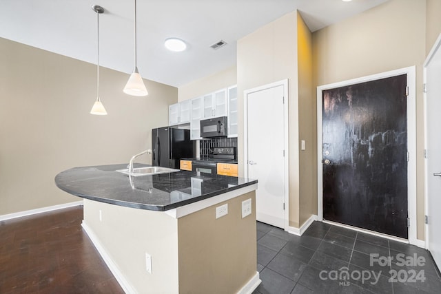 kitchen featuring sink, black appliances, hanging light fixtures, a kitchen island with sink, and white cabinets