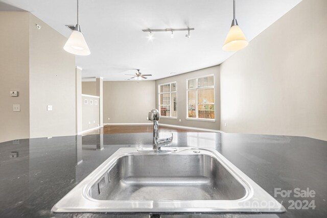 kitchen with sink, decorative light fixtures, and ceiling fan