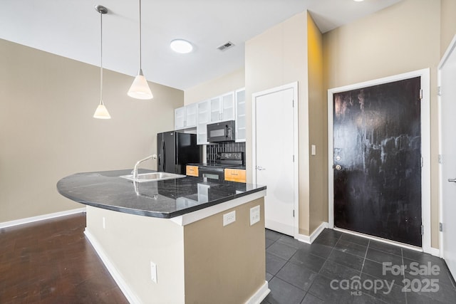 kitchen with a sink, an island with sink, visible vents, white cabinets, and black appliances