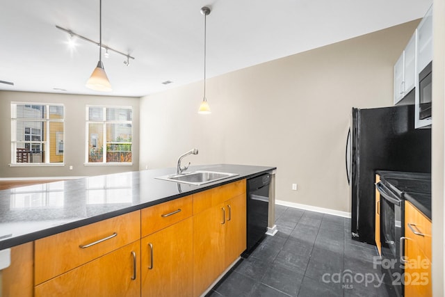 kitchen with a sink, pendant lighting, baseboards, black appliances, and track lighting