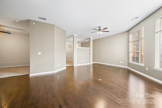 unfurnished living room featuring ceiling fan, visible vents, and wood finished floors