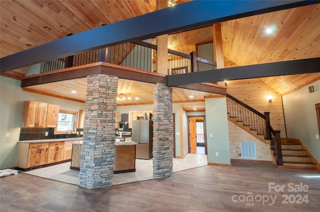 kitchen featuring light hardwood / wood-style floors, light brown cabinets, wood ceiling, stainless steel fridge, and ornate columns